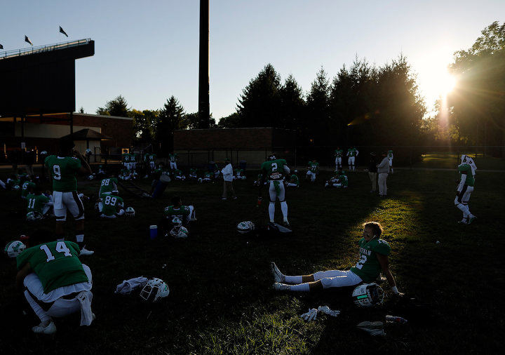 September - 3rd place sports feature - Dublin Coffman Trey Hedderly (12) listens to music in their outdoor locker room before their game against Hilliard Davidson at Dublin Coffman High School.(Kyle Robertson / The Columbus Dispatch)