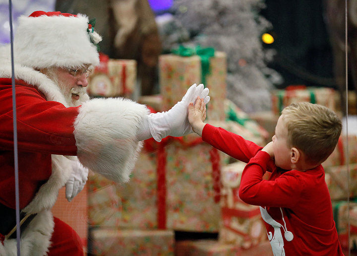 November - 2nd place feature - Decker Dowdy, 3, touches Santa through a "magic shield" at Cabela's in Columbus. Cabela's is only allowing 25 appointments each night to see Santa.  Kyle Robertson / The Columbus Dispatch