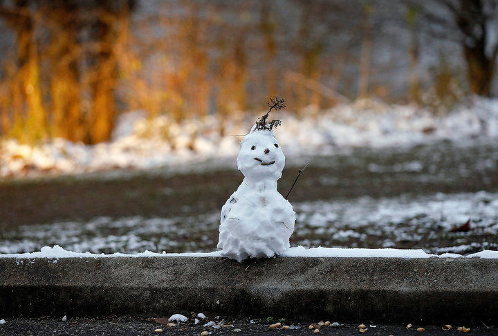 December - 2nd place illustration - A mini-snowman sits atop of a parking block in James J. Thomas Park near the Scioto River in Columbus. Kyle Robertson / The Columbus Dispatch