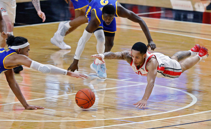 December - 3rd place sports - Ohio State guard CJ Walker (13) dives for the ball against Morehead State forward Johni Broome (4) during the first half of their game at Covelli Center in Columbus. Kyle Robertson / The Columbus Dispatch