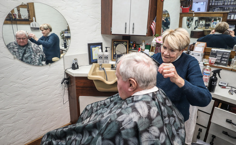 January - Portrait - 1st place - Connie Durand, 75, cuts Paul Brzozka’s  hair at the Golden Razor Barber Shop in Toledo.  (Jeremy Wadsworth / The Blade)