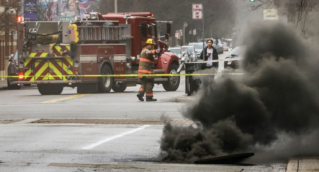 January - Spot News - 1st place - Firefighters on the scene of an underground electric fire on Huron Street in Toledo.  (Jeremy Wadsworth / The Blade)