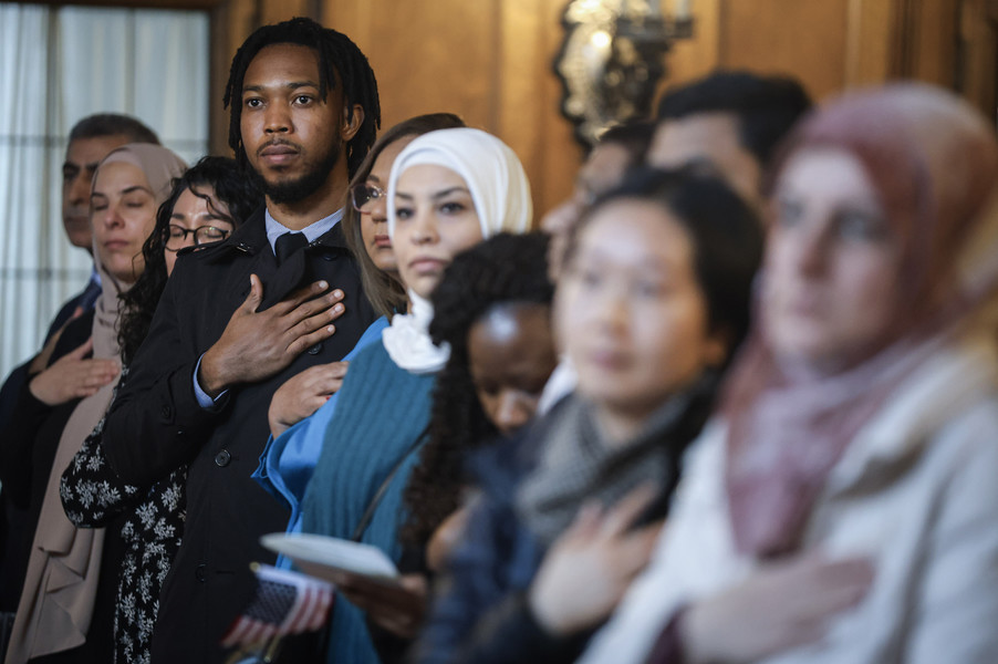 February -  General News - 3rd place - Kizito Akunna recites the Pledge of Allegiance during a naturalization ceremony at the Toledo Club in Toledo.   (Jeremy Wadsworth / The Blade)}