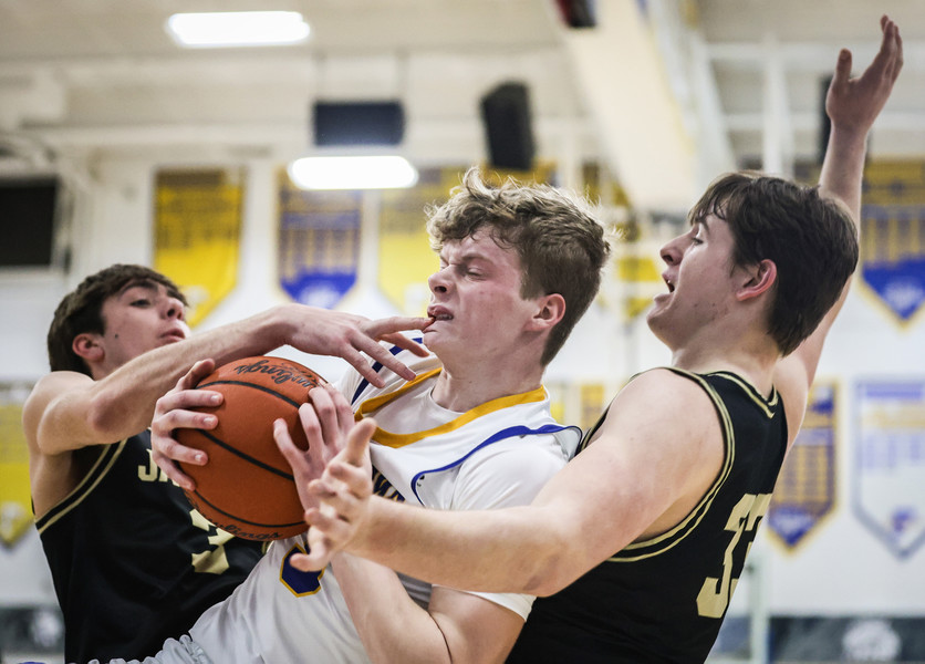 February -  Sports - 3rd place - Findlay’s Ben Best (center) drives to the basket against  Perrysburg’s Carter Young (left) and Matt Hubbard during a game in Findlay.   (Jeremy Wadsworth / The Blade)}