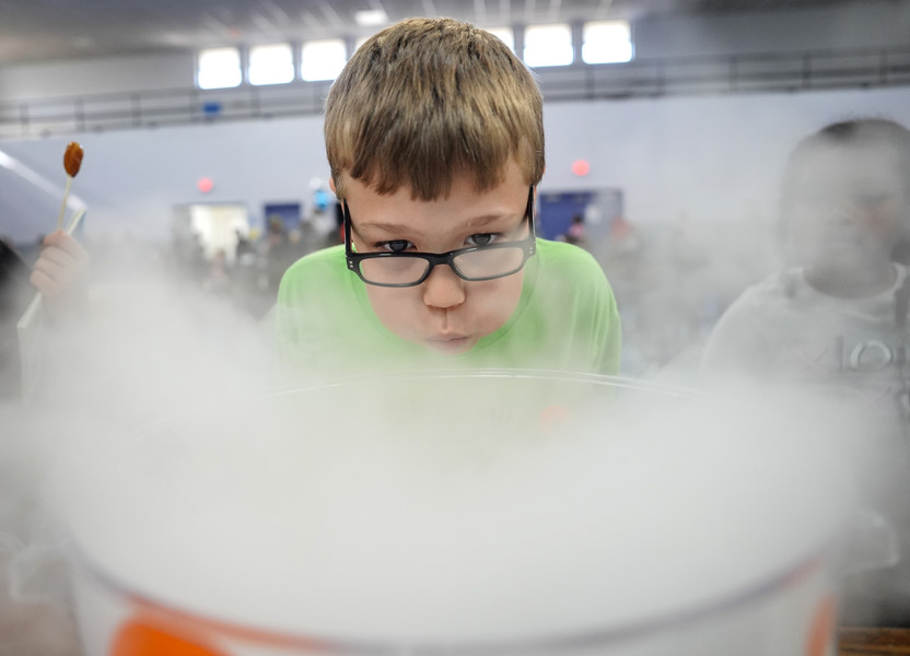 September - Feature - 1st place - Hayden Hawkins, 10, blows on smoke from a COSI dry ice demonstration at event in which AT&T gave away 125  refurbished laptops at the East Toledo Family Center in Toledo.  (Jeremy Wadsworth / The Blade)