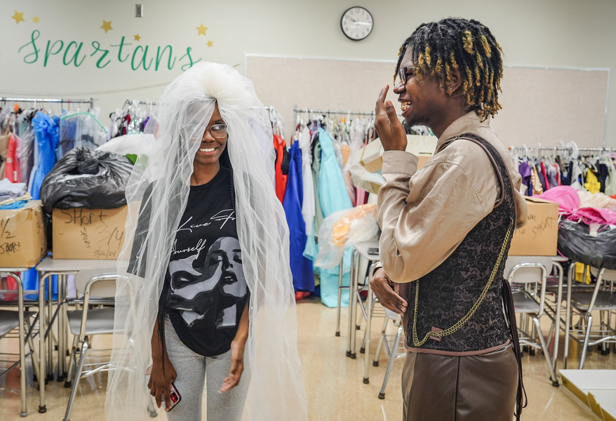 September - General News - 2nd place - Seniors Angelina Carter (left) and Kristian Woods-Boykin laugh as Angelina tries on a wedding veil while getting formal wear ready to sell for a fundraiser at Start High School in Toledo. Marketing students at Start High School are having a fundraiser in which affordable attire is being made  available to teens who might otherwise have difficulty in buying special occasion wear.  (Jeremy Wadsworth / The Blade)