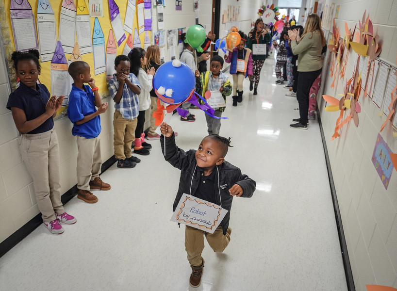 November - Feature - 2nd place - Kindergartner Omahd Jones marched proudly during a “Balloons over Broadway” parade at McKinley STEMM Academy in Toledo. Kindergarten students at McKinley STEMM Academy wrapped up a series of project-based learning activities with a Thanksgiving Day style balloon parade. Students have worked hard to design a variety of balloons and students have also planned the parade route. (Jeremy Wadsworth / The Blade)