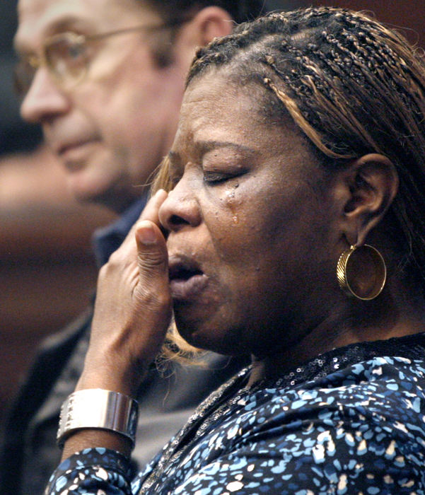 General News - 1st place - Jaqueline Carlton, sister of Jerry Laury, a Canton taxi driver, who was fatally shot by Raul Benitez Maranon, crys during sentencing in a Summit County courtroom. In the background is Dave Harmon, owner of the Yellow Cab Co. (Scott Heckel / The (Canton) Repository)