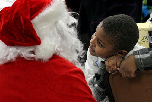 General News - 2nd place - Six year old Mekhi D. gets close and looks Santa in the eye, asking him some questions during "Shop with a Jock Day" at Walmart in Strongsville. Cribbs and a host of Browns players took 50 children from the Cleveland Christian Home on a $100 shopping spree.  (Lynn Ischay / The Plain Dealer)