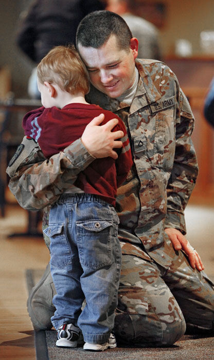 General News - 3rd place - Pvt 1st Class Josh Wholaver, from Hilliard, gives his son Nate, 2, a big hug after arriving at the Westerville Christian Church for a welcome home ceremony.  He and fellow members of the Ohio National Guard's 684th Medical Company returned early from what was supposed to be a year long deployment in support of Operation Enduring Freedom.   (Chris Russell / The Columbus Dispatch)