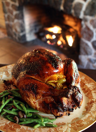 Illustration - 3rd place - Maple-glazed turkey rests in front of the fireplace at the historic Welshfield Inn, scene of  a Thanksgiving feast prepared by owner Scott  Kuhn, and chef Amber Schuetzman. (Peggy Turbett / The Plain Dealer)