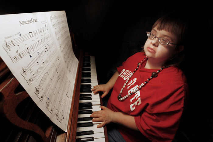 Portrait - 2nd place - Alison Foose, who has Down Syndrome,  lives independently with a roommate in Worthington and was practicing her piano piece, "Amazing Grace" that she will performing in a local Christmas presentation.  (Chris Russell / The Columbus Dispatch)