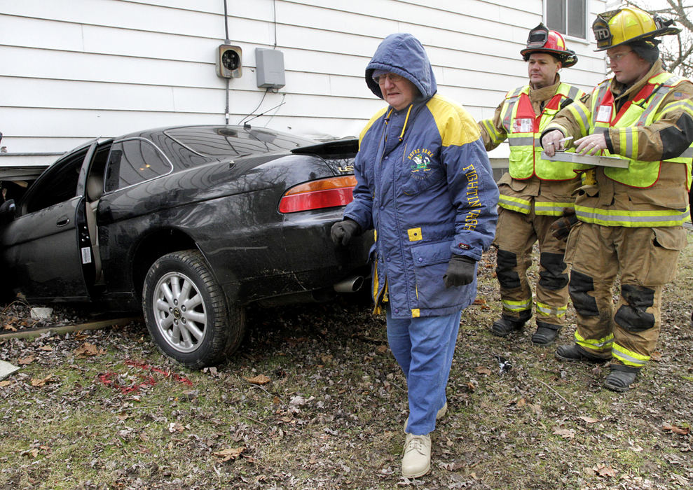 Spot News - 3rd place - A resident reacts after this Lexus sedan crashed into the basement level of her home. Two young people and an adult male driver were transported to Springfield Regional Medical Center with unknown injuries after the crash. (Barbara J. Perenic / Springfield News-Sun)