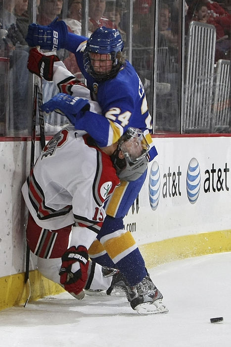 Sports - 1st place - Ohio State's Danny Dries (19) is taken down to the ice by Lake Superior State's Kevin Czuczman (24) in the second period of their hockey game at Value City Arena. (Neal C. Lauron / The Columbus Dispatch)