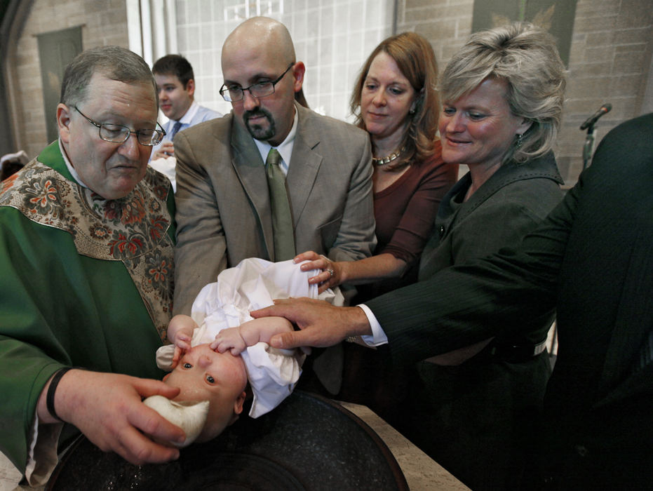 Story - 1st place - Anna Turso is baptized at St. Christopher's in Grandview Heights. (Chris Russell / The Columbus Dispatch)