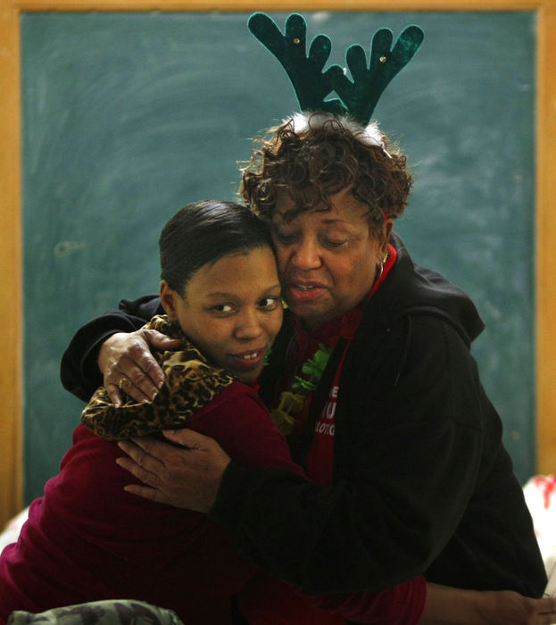 Story - 2nd place - Lynn Green (left)  gets a hug from Sandra Waters-Holley at the McKendree United Methodist Church in Columbus. (Jonathan Quilter / The Columbus Dispatch)