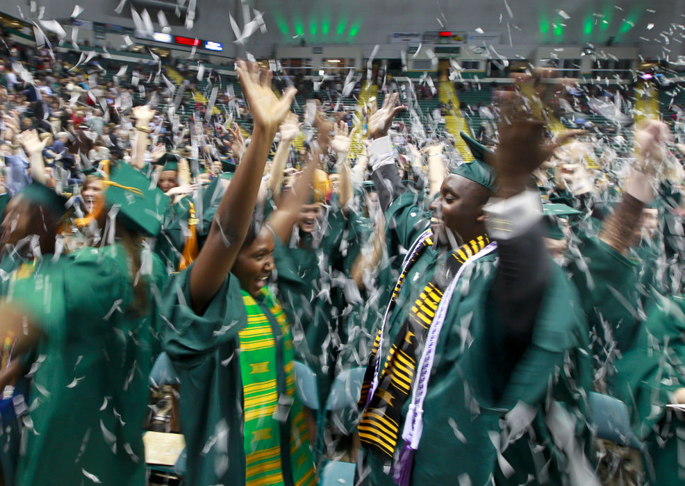 General News - 2nd placeHusband and wife Mercy Wamwara and Sammy Loonkishu celebrate after both received Bachelor of Science degrees in nursing during Fall Commencement at the Nutter Center. (Barbara J. Perenic / Springfield News-Sun)