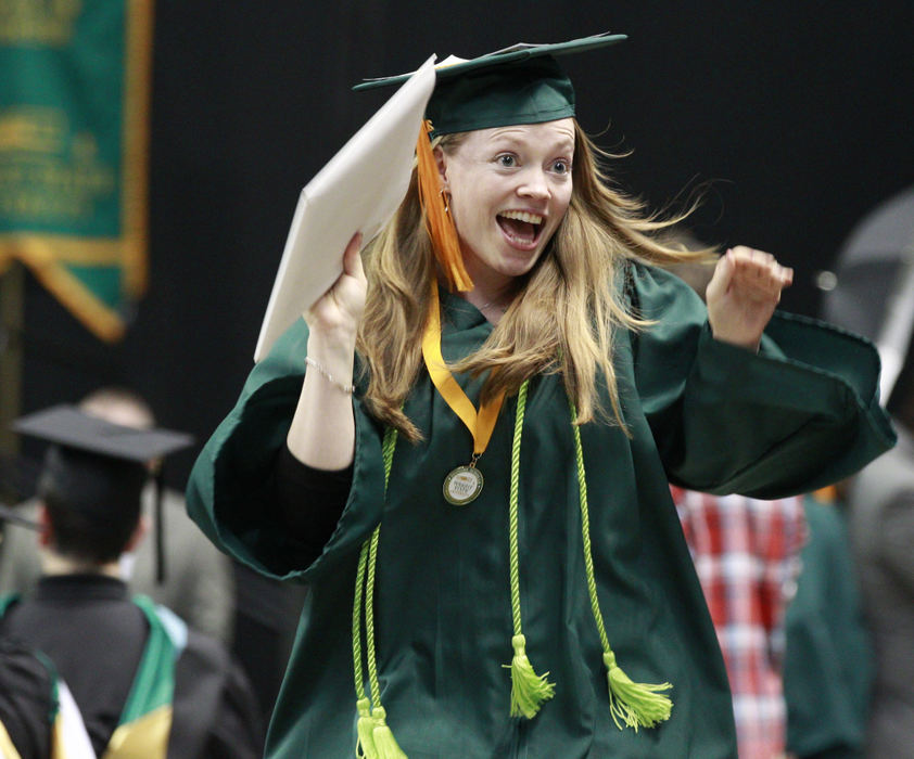 General News - 3rd placeLaura Churchman waves to her family and husband after receiving her Bachelor of Science degree in nursing during Fall Commencement at the Nutter Center. (Barbara J. Perenic / Springfield News-Sun)