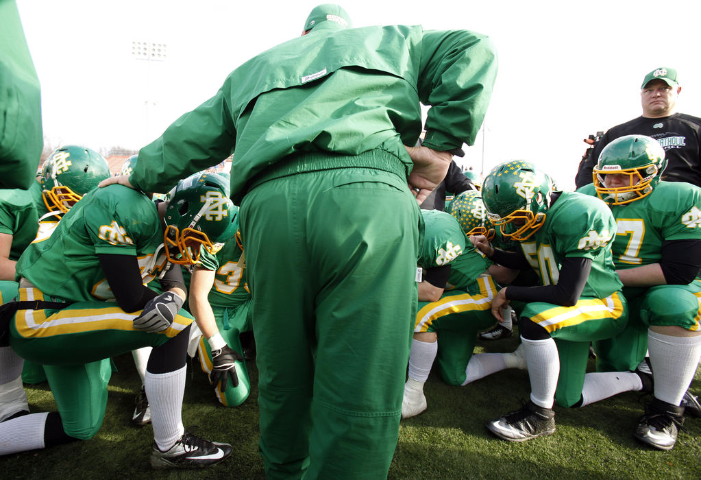 Sports Feature - 1st placeNewark Catholic head coach Bill Franks speaks to his team after losing to Marion Local on the last play of the game in the Division VI state championship game at Paul Brown Tiger Stadium in Massillon. (Kyle Robertson / The Columbus Dispatch)