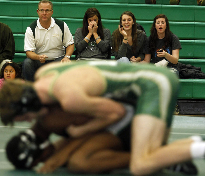 Sports Feature - 3rd placeMatt and Chrissy Jacobs, Carly Willson, and Makenzie Colvin watch as Dublin Jerome's Alex Jacobs and Dublin Coffman's Adnan Mohamud wrestle in the 132lb  weight class match during the Battle of Dublin at Jerome.  (Lorrie Cecil / ThisWeek Newspapers)