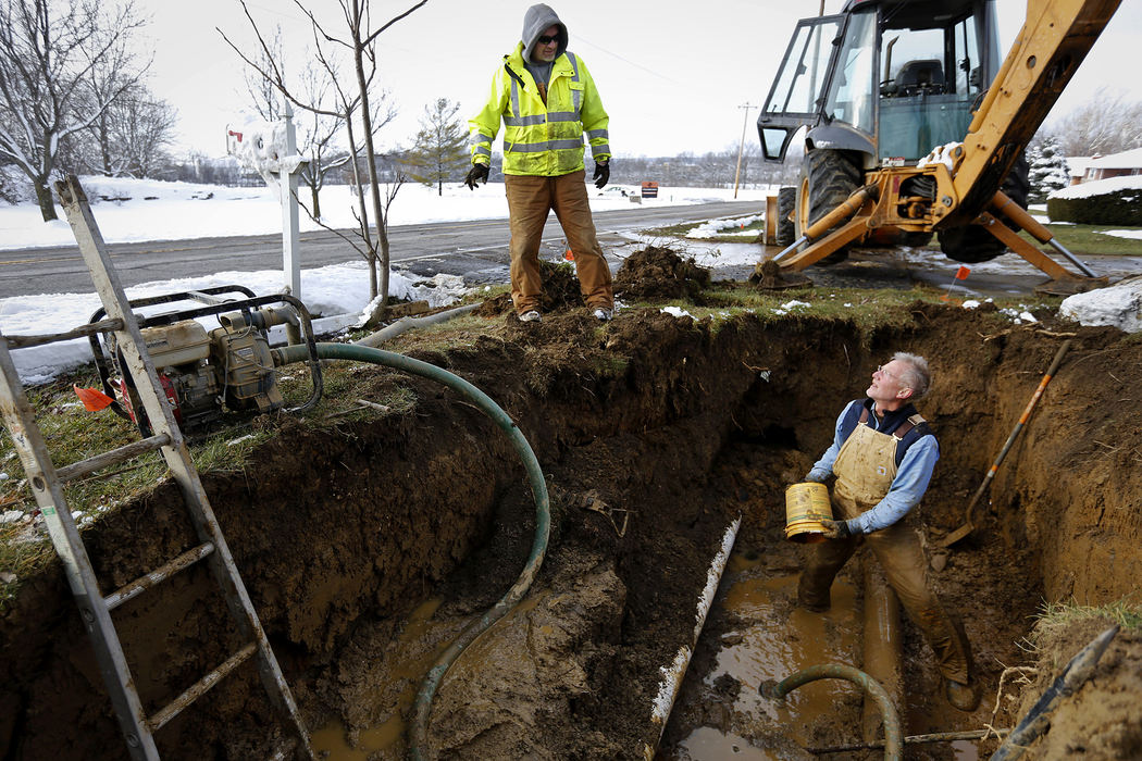 Spot News - 1st placeVillage of Lithopolis mayor Eric Sandine (left) and city administrator Ed VanVickle, (right) work to fix a water-main break in below-freezing temperatures that has cut off water to 600 residents which constitutes about half the village population. This was the second break the pair had to fix in one day on top of being up until 1 am the previous night plowing snow.  (Eamon Queeney / The Columbus Dispatch)