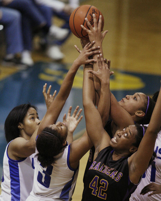 Sports - HMReynoldsburg's Destini Cooper (42) goes for a rebound with teammate Alyssa Rice (45)  against  Gahanna's Nikki Campbell-Muriente  (33)  and Chrishna Butler (3) during a game at Gahanna Lincoln High School. (Fred Squillante / The Columbus Dispatch)