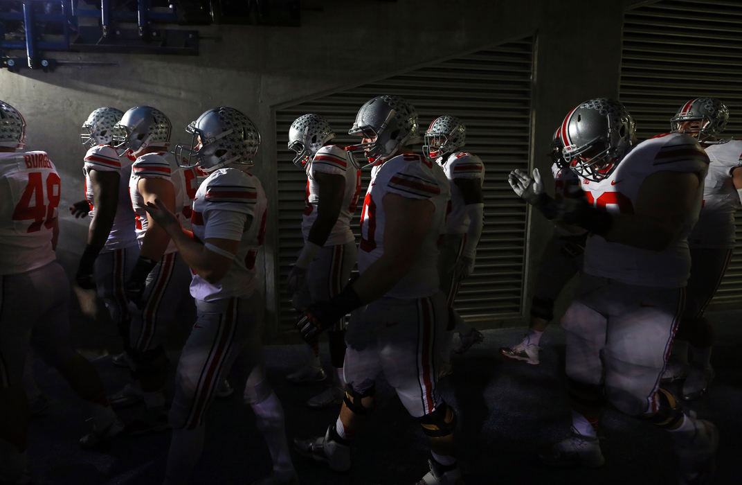 Sports Feature - 1st placeOhio State football players wait to enter the field prior to the first quarter of the Big Ten championship football game against the Michigan State Spartans at Lucas Oil Stadium in Indianapolis. (Adam Cairns / The Columbus Dispatch)