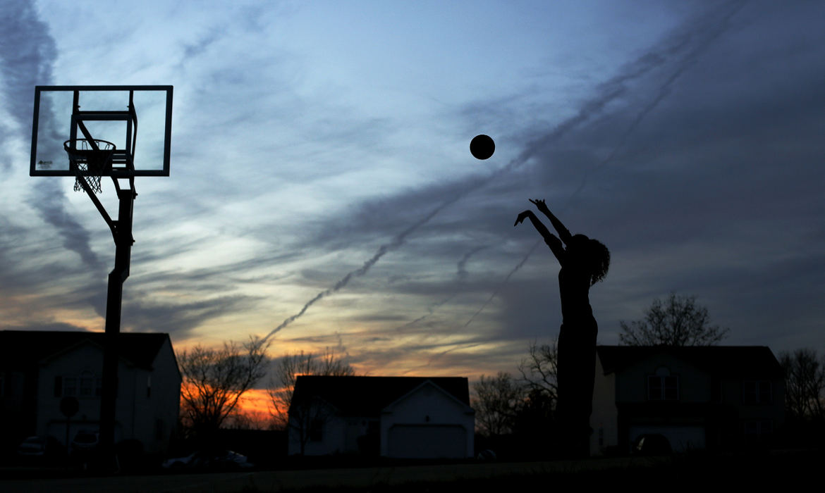 Story - 1st placeBexely Wallace works on her jump shot during a practice with her father, Chris, in front of her house in Pickerington.  What sets Bexley apart from other 6-2 players at her age is her ball handing skills.    Some scouts have already labeled Bexley the number one recruit in the class of 2018.   (Kyle Robertson / The Columbus Dispatch)