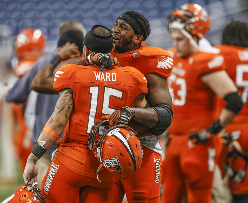 Sports Feature - 2nd place - Bowling Green State University players Ryland Ward (15) and Gabe Martin (11) console each other after losing to Northern Illinois University 51-17 in the MAC football championships at Ford Field in Detroit. (Andy Morrison / The (Toledo) Blade)