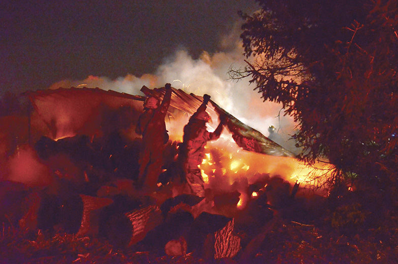 Spot News - 1st place - Lisbon firefighters battle the cold fueled by high winds as they work to contain and extinguish a fire of an outdoor wood furnace heating system at the Wayne Willis Farm on Freeman Road.  (Patricia Schaeffer / The (Lisbon) Morning Journal)