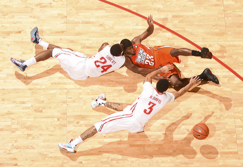 Sports - 1st place - Dayton's Kyle Davis and Jordan Sibert collide with Jehvon Clark of Bowling Green while scrambling for a loose ball.  (Erik Schelkun / Elsestar Images)