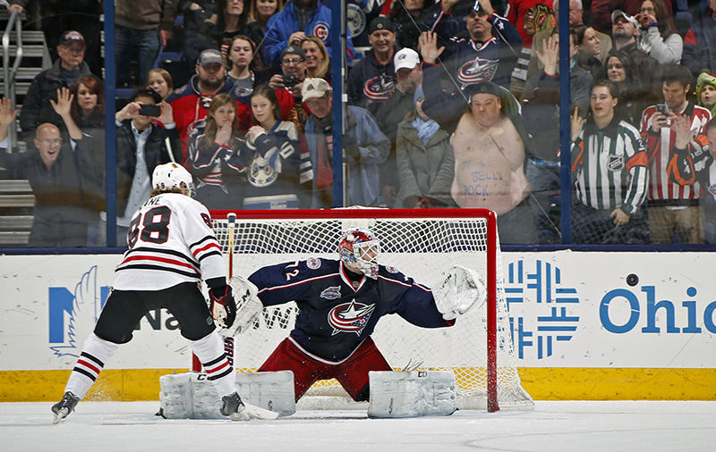 Sports - 3rd place - The Columbus Blue Jackets biggest fan Kevin Schroeder shakes his belly as Blue Jackets goalie Sergei Bobrovsky (72) makes a save on Chicago Blackhawks right wing Patrick Kane (88) shot during a shootout in their NHL game Nationwide Arena in Columbus. (Kyle Robertson / The Columbus Dispatch )