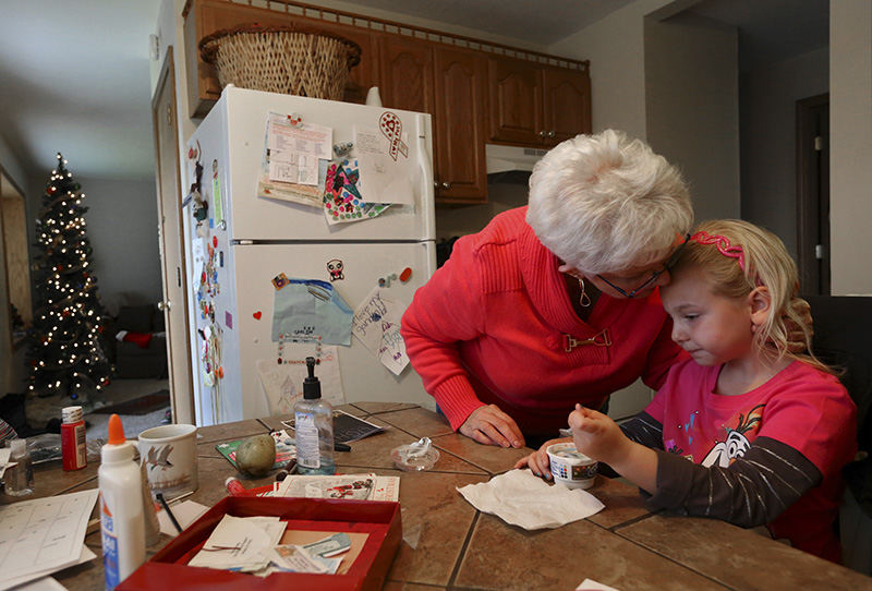 General News - 1st place - Carlene Davis-Dale gives a kiss to granddaughter Ava Lok who lives with her. Carlene has custody of Ava due to her sons Drake Lok's drug addiction which has prevented him from being a father due to his heroin use. (Eric Albrecht / The Columbus Dispatch)