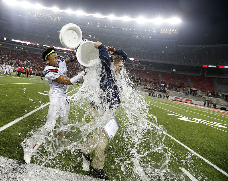 Sports Feature - 1st place - Bishop Hartley head coach Brad Burchfield is doused with ice water by player Rian Anderson (2) as time expires in the Division IV state championship football game against Steubenville at Ohio Stadium in Columbus. (Barbara J. Perenic / The Columbus Dispatch)