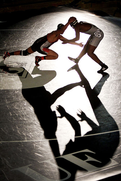 Sports Feature - 2nd place - Perkins' Kordell Chaney lunges to take down Sandusky's Jerell Wells in a wrestling event under the spotlight. (Angela Wilhelm / Sandusky Register)