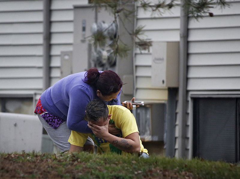 Spot News - HM - Two people are overcome with grief after Columbus Police were on the scene at the Wynds apartments on Christmas morning of an early-morning shooting on Courtside Drive, where two people were found dead in a car.  (Tom Dodge / The Columbus Dispatch)