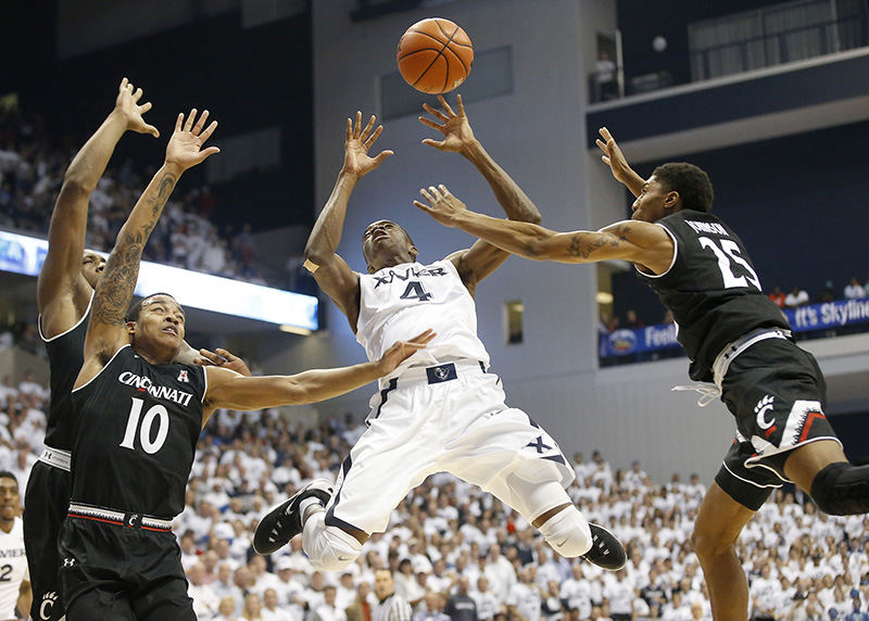 SSports - 1st place - Xavier Musketeers guard Edmond Sumner (center) loses the ball on the way to the basket as Cincinnati Bearcats guard Troy Caupain (10) and Kevin Johnson (25) defends in the second half during the 83rd annual Crosstown Shootout game at Cintas Center in Cincinnati. (Kareem Elgazzar / Cincinnati Enquirer)