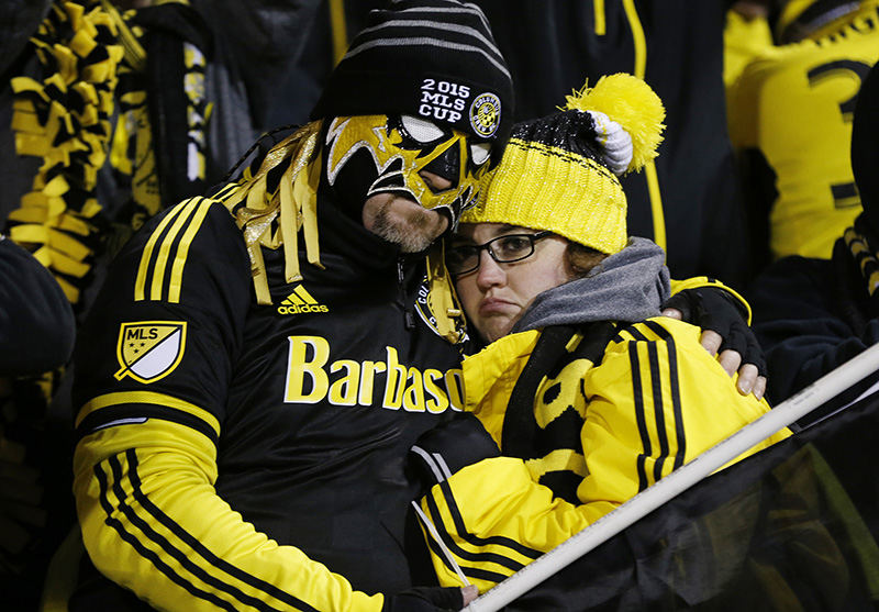 Story - HM - Bruce "Mask Juice" Lewis and Jennifer Johnson embrace after the MLS Cup game between the Columbus Crew SC and the Portland Timbers at Mapfre Stadium in Columbus. The Timbers defeated the Columbus Crew SC 2 - 1.  (Eamon Queeney / The Columbus Dispatch)