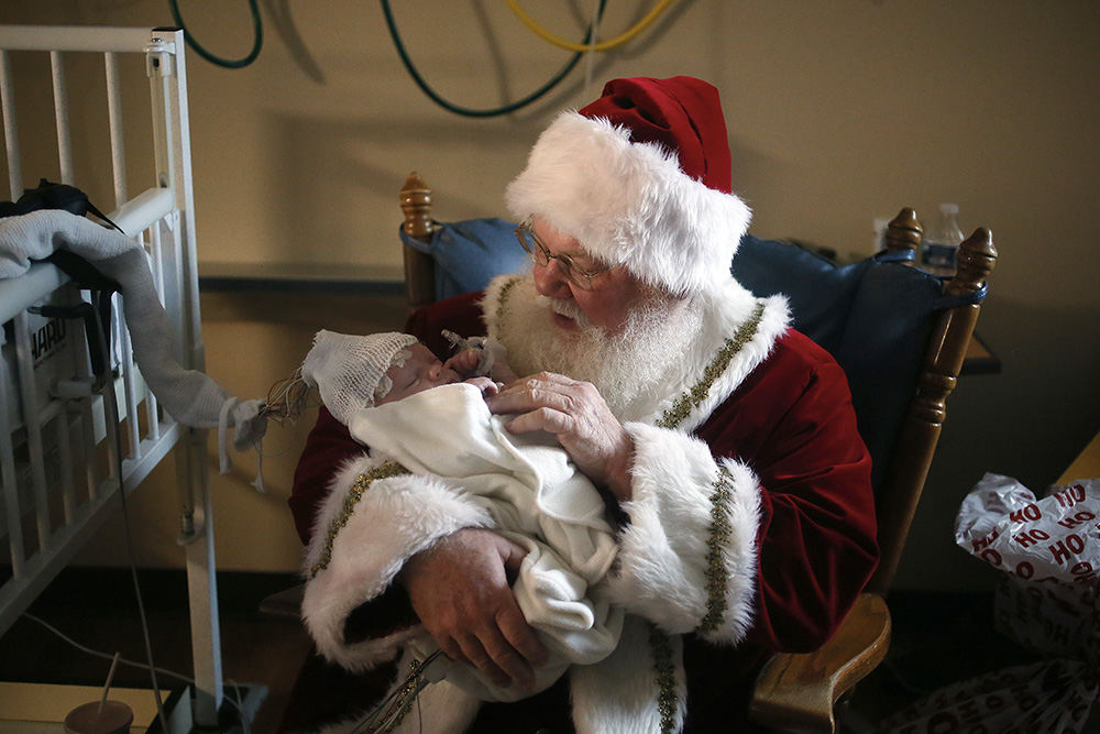 General News - 2nd place - Santa holds 3-week old patient Silas Squires of Cumberland at Akron Children's Hospital. (Leah Klafczynski / Akron Beacon Journal)