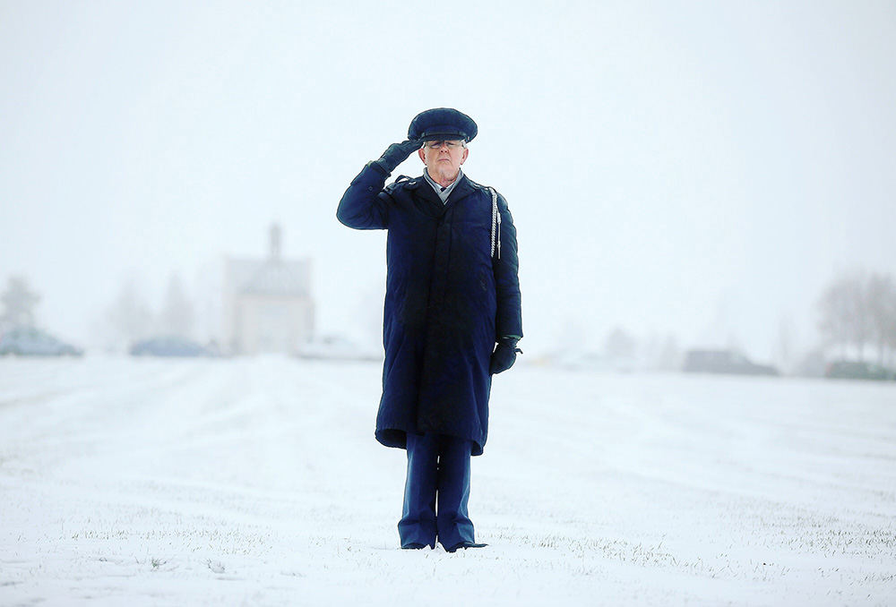 Portrait - HM - A veteran looks onward during the 21-gun salute at Western Reserve National Cemetery in Rittman. Before the ceremony, graves were decorated with 7,500 donated wreaths for the holidays. (Leah Klafczynski / Akron Beacon Journal)