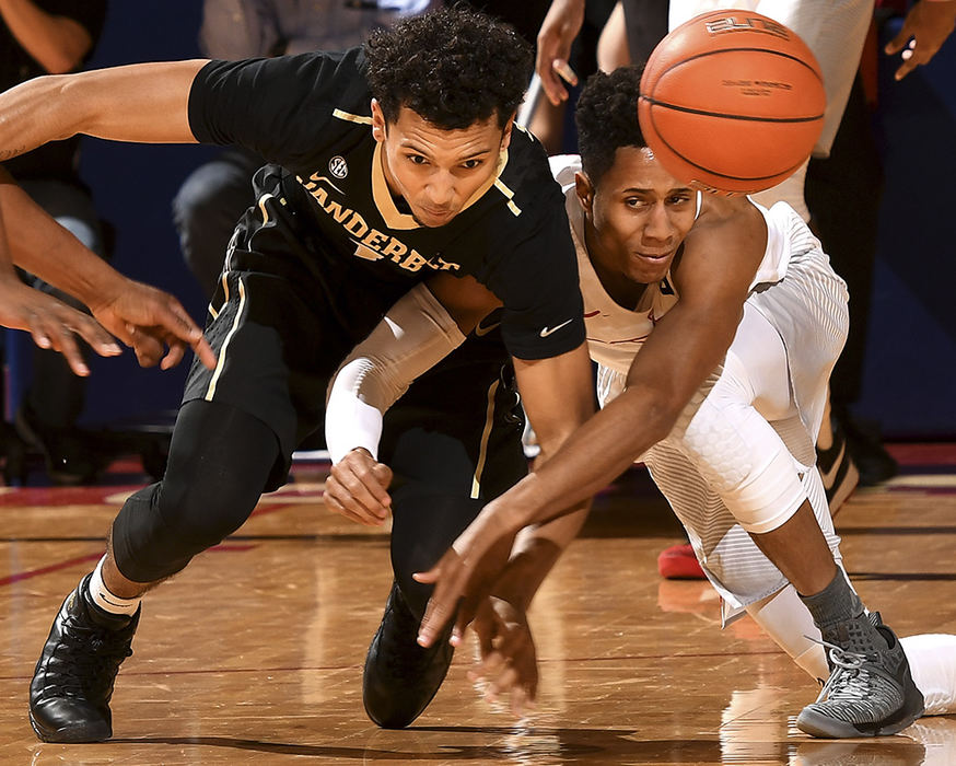 Sports - 3rd place - Dayton's Darryl Davis and Payton Willis of Vanderbilt get tangled up chasing after a loose ball during the first half of action at UD Arena. The Dayton Flyers went on to win the game 68-63.  (Erik Scelkun / Elsestar Images)