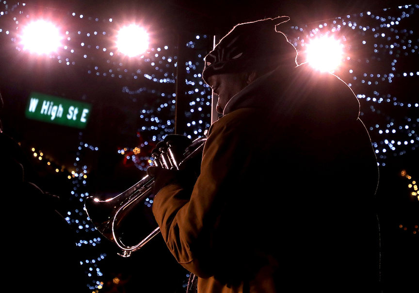 Feature - 1st place - Dean Simms performs with Par Tolliver during the Holiday in the City festival in downtown Springfield. (Bill Lackey / Springfield News-Sun)