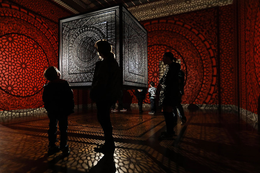 Feature - HM - People look at 'Intersections' an installation by artist Anila Quayyum Agha from her Between Light and Shadow exhibit  at the Toledo Museum of Art.(Rebecca Benson / The Blade)