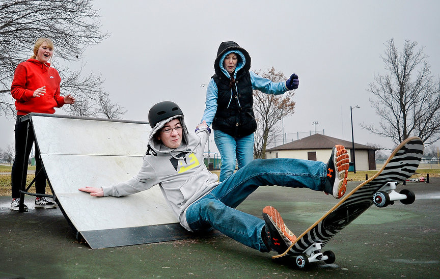 Feature - HM - Brenden Cottman (center) reaches out for his mother, Brandy Suman (right) as he tumbles off a skateboard as his sister, Lily Suman (left) watches from behind the ramp at the skate park in Celina’s Westview Park.(Daniel Melograna / The Daily Standard)