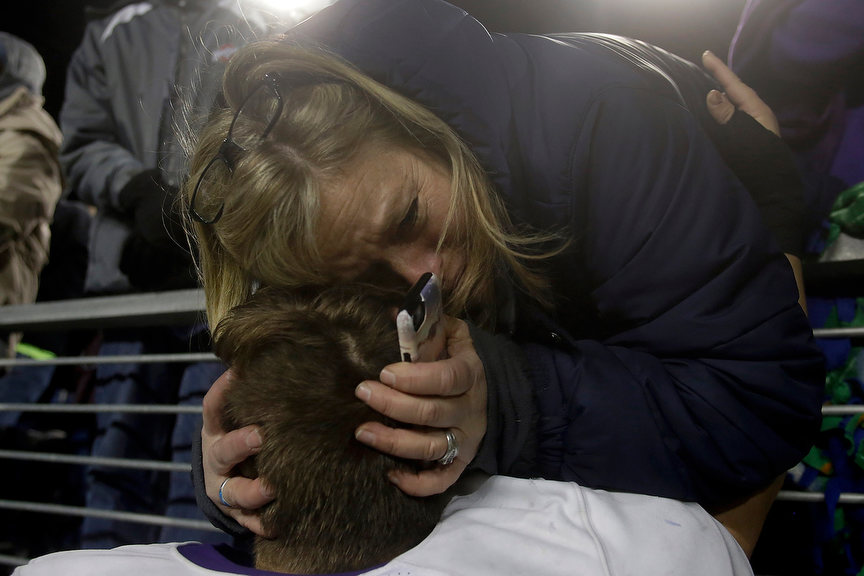 Sports Feature - 2nd place - Julie Marasco becomes emotional as she celebrates with her son, Dom Marasco, after Pickerington Central's 21-14 victory over Cincinnati Elder in the OHSAA Division I state championship game at Tom Benson Hall of Fame Stadium in Canton.(Shane Flanigan / ThisWeek Community News)