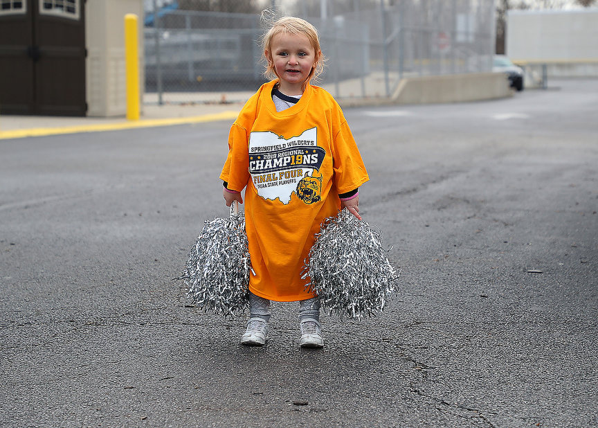 Sports Feature - HM - Addison Callison, 3, watches the Springfield Wildcats football team bus drive away from Springfield High School in route to their state semifinal game against Elder High School. (Bill Lackey / Springfield News-Sun)