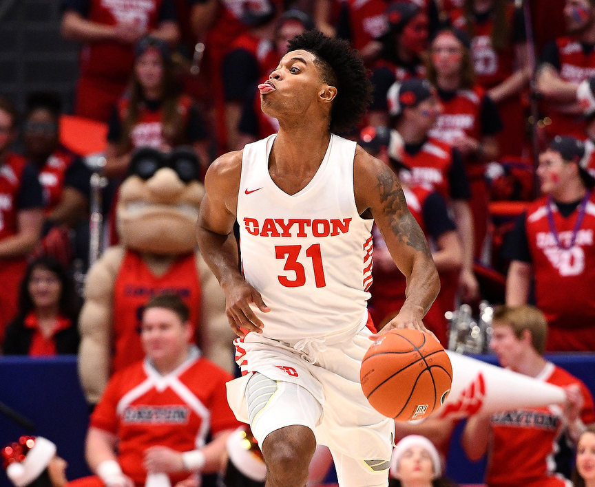 Sports - HM - Dayton's Jhery Matos sticks out his tongue as he dribbles the ball up the court against Drake. The Flyers defeated Drake 78-47(Erik Schelkun / Elsestar Images)