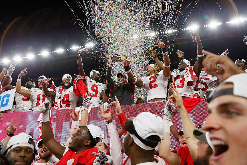 Story - 1st place - Ohio State head coach Ryan Day hoists the Stagg Championship Trophy following their 34-21 win over the Wisconsin Badgers in the Big Ten Championship Game at Lucas Oil Stadium in Indianapolis.(Adam Cairns / The Columbus Dispatch)