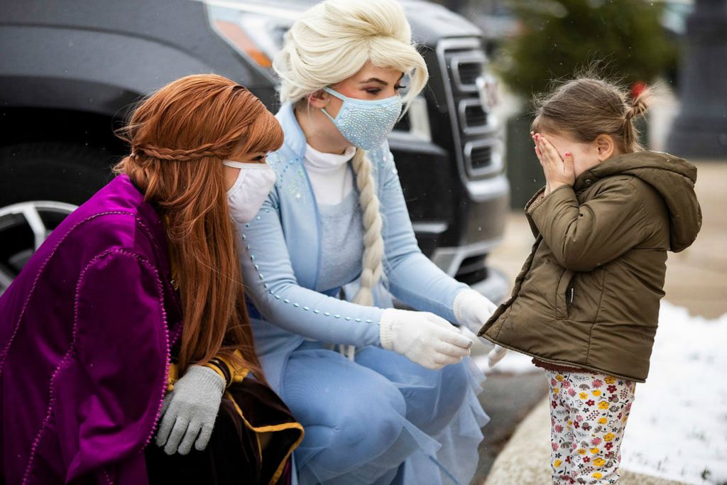 Feature - 2nd place - Clover Moore (right) plays peekaboo with Ana (left) and Elsa in downtown Perrysburg. Rebecca Benson / The Blade