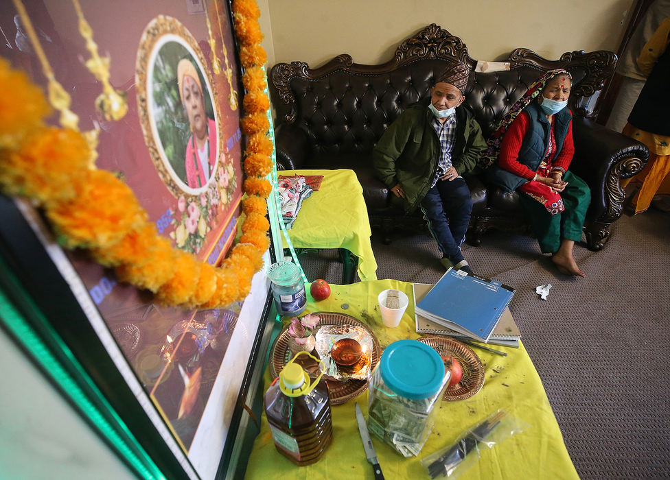 General News - 1st place - Loved ones gather to mourn the death of Phul Archarya during a Hindu funeral ceremony at the family's home, in Cuyahoga Falls. On Nov. 25 Phul lost her battle against COVID-19. Jeff Lange / Akron Beacon Journal